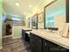 Bathroom boasts dual vanities, marble countertops, modern fixtures, and a step-in shower behind glass at 4713 White Store Rd, Wingate, NC 28174