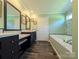 Spacious bathroom with double vanity, modern fixtures, and soaking tub perfect for relaxation at 4713 White Store Rd, Wingate, NC 28174