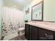 Bathroom features marble-style countertop, dark wood cabinet, and shower at 4713 White Store Rd, Wingate, NC 28174