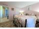 Comfortable bedroom with a view of a connected room. The room is pink with a black bedframe at 4713 White Store Rd, Wingate, NC 28174
