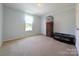 Bright bedroom with neutral walls, carpet, and a window; minimal furnishings at 4713 White Store Rd, Wingate, NC 28174