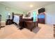 Comfortable bedroom with patterned bedding, wood furniture, and neutral carpet for a relaxing retreat at 4713 White Store Rd, Wingate, NC 28174