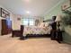 Cozy bedroom featuring floral bedding, wooden accents, and soft lighting, creating a tranquil atmosphere at 4713 White Store Rd, Wingate, NC 28174