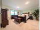 Bright bedroom with a dark wood bedroom suite, neutral walls, and ample natural light at 4713 White Store Rd, Wingate, NC 28174