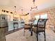 Charming dining area features floral wallpaper, a modern chandelier, and a glass-top table at 4713 White Store Rd, Wingate, NC 28174