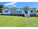 Manufactured home with light beige siding, white trim, a brick foundation and a manicured lawn at 4713 White Store Rd, Wingate, NC 28174