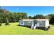 Single-story home with a small front porch and a well-maintained lawn in a serene, wooded setting at 4713 White Store Rd, Wingate, NC 28174