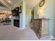 Hallway with decorative chest of drawers, lamp, and wall art; views into the living space at 4713 White Store Rd, Wingate, NC 28174