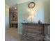 Hallway with decorative chest of drawers, lamp, and wall art; views into another room at 4713 White Store Rd, Wingate, NC 28174