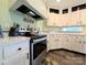 Close up of a kitchen featuring a stainless steel stove, white cabinets, and sleek countertops at 4713 White Store Rd, Wingate, NC 28174