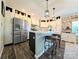 Modern kitchen boasting white cabinets, a stainless steel refrigerator, and a stylish breakfast bar at 4713 White Store Rd, Wingate, NC 28174