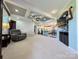Open-concept living room leading to the kitchen and dining area, with tray ceiling and comfortable seating at 4713 White Store Rd, Wingate, NC 28174