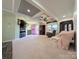 Open-concept living space with a pink front door, fireplace, television, and comfortable seating at 4713 White Store Rd, Wingate, NC 28174