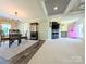 Inviting living space with a pink front door, fireplace, television, and decorative furnishings at 4713 White Store Rd, Wingate, NC 28174