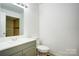 Bathroom features a modern vanity, toilet, and a shower with neutral-toned tiles at 4806 Spring Lake Dr # D, Charlotte, NC 28212