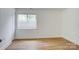 Bedroom featuring wood-look flooring, a window, and a closet at 4806 Spring Lake Dr # D, Charlotte, NC 28212