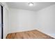 Bright bedroom featuring wood-look flooring, a closet, and natural light at 4806 Spring Lake Dr # D, Charlotte, NC 28212