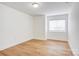 Bright bedroom featuring wood-look flooring and natural light from window at 4806 Spring Lake Dr # D, Charlotte, NC 28212