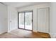 A bedroom with a sliding glass door leading to a balcony, plus closet for storage at 4806 Spring Lake Dr # D, Charlotte, NC 28212