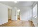Bedroom leading to bathroom with wood-look flooring and a closet at 4806 Spring Lake Dr # D, Charlotte, NC 28212