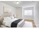 Bedroom featuring wood-look floors, queen bed, and a view from the window at 4806 Spring Lake Dr # D, Charlotte, NC 28212