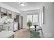 The kitchen has gray cabinets and stainless steel appliances with a small eating table in the corner at 4806 Spring Lake Dr # D, Charlotte, NC 28212