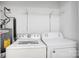 Laundry room equipped with a washing machine, dryer, and storage shelf at 4806 Spring Lake Dr # D, Charlotte, NC 28212
