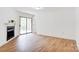 Living area has wood floors, a fireplace and sliding doors leading to the outside at 4806 Spring Lake Dr # D, Charlotte, NC 28212