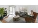 Cozy living room features modern decor, a fireplace, and sliding doors to a balcony at 4806 Spring Lake Dr # D, Charlotte, NC 28212