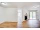 The living area has wood floors, a fireplace, and an adjacent room visible at 4806 Spring Lake Dr # D, Charlotte, NC 28212