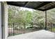 Covered porch with black metal railings overlooks green trees and natural scenery at 4806 Spring Lake Dr # D, Charlotte, NC 28212