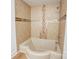 A tiled shower features a decorative tile accent border and modern fixtures at 4806 Spring Lake Dr # D, Charlotte, NC 28212
