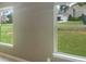 View of the backyard from inside the house, showing a green lawn and neighboring houses at 5003 Tremont Dr, Indian Trail, NC 28079