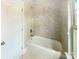 Bathroom with white tub and shower with light tiled walls at 5003 Tremont Dr, Indian Trail, NC 28079