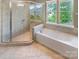 Bathroom boasts separate glass shower and modern tub at 5003 Tremont Dr, Indian Trail, NC 28079