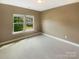 Bright, unfurnished bedroom with neutral carpet, a large window, and view to the outside at 5003 Tremont Dr, Indian Trail, NC 28079