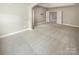 Large open room with plush carpet, neutral walls, and multiple doorways that lead to other parts of the home at 5003 Tremont Dr, Indian Trail, NC 28079