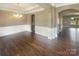 Inviting dining room with hardwood floors, wainscoting, chandelier, and large windows with natural light at 5003 Tremont Dr, Indian Trail, NC 28079