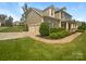 Charming two-story home with a three-car garage, manicured lawn, and well-kept landscaping at 5003 Tremont Dr, Indian Trail, NC 28079