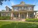 Charming two-story home featuring a welcoming front porch and beautifully landscaped front yard at 5003 Tremont Dr, Indian Trail, NC 28079