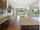 Modern kitchen featuring an island, granite countertops, tile backsplash, and stainless steel appliances at 5003 Tremont Dr, Indian Trail, NC 28079