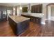 Modern kitchen features a granite countertop island, stainless steel appliances, and dark cabinets at 5003 Tremont Dr, Indian Trail, NC 28079