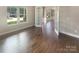 Open living area with hardwood floors, French doors, and bright windows with neighborhood views at 5003 Tremont Dr, Indian Trail, NC 28079