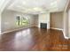 Spacious living room with hardwood floors, fireplace, and bright windows overlooking the backyard at 5003 Tremont Dr, Indian Trail, NC 28079
