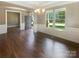 Elegant living room with hardwood floors, wainscoting, and large windows overlooking the front yard at 5003 Tremont Dr, Indian Trail, NC 28079
