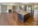 Open concept living space with fireplace, hardwood floors, and eat-in kitchen area at 5003 Tremont Dr, Indian Trail, NC 28079