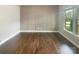 Versatile room with hardwood floors, grid wall feature, and ample natural light from a large window at 5003 Tremont Dr, Indian Trail, NC 28079