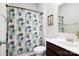 Cozy bathroom featuring a shower with a floral curtain, white fixtures, and a dark wood vanity at 5069 Thomasville Dr, Belmont, NC 28012