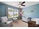 Charming Bedroom with blue walls, chair, baby bed, ceiling fan, and natural light from the double windows at 5069 Thomasville Dr, Belmont, NC 28012