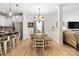 Open-concept dining room connected to the kitchen, features a dining table and view into living room at 5069 Thomasville Dr, Belmont, NC 28012